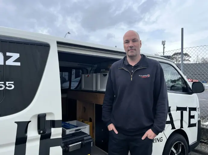 man beside work van 